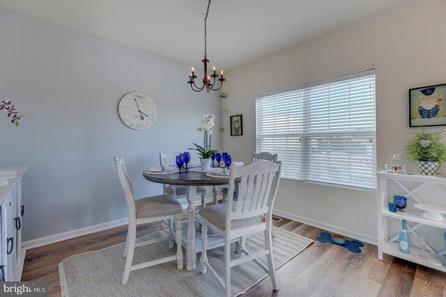 20868 Brunswick Ln, Millsboro, DE 19966 - dining area with an inviting chandelier, lofted ceiling, and hardwood / wood-style floors