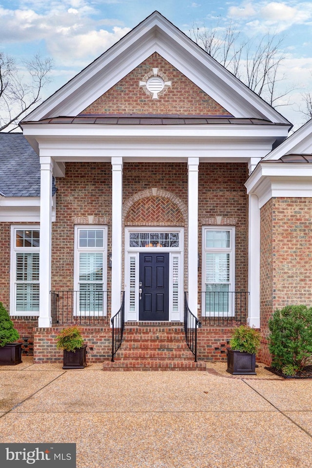 view of exterior entry with a porch