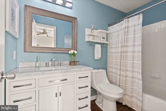 full bathroom with shower / tub combo with curtain, toilet, vanity, hardwood / wood-style flooring, and ceiling fan