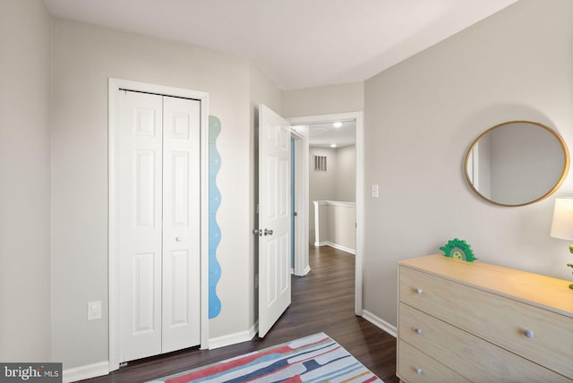 bedroom featuring a closet and dark hardwood / wood-style floors