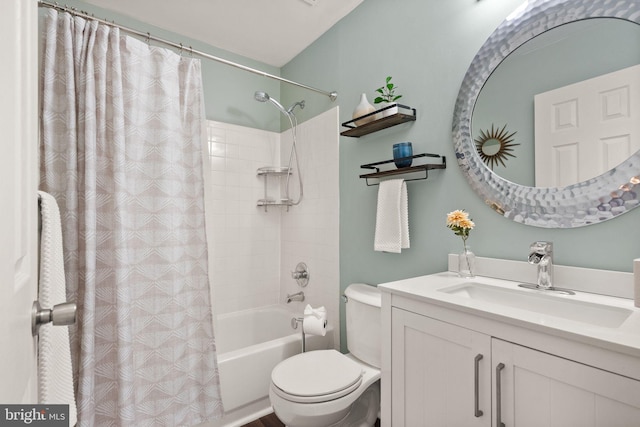 full bathroom featuring shower / tub combo with curtain, vanity, and toilet