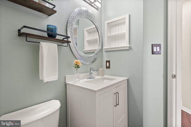 bathroom featuring vanity and toilet