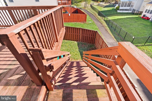 wooden deck with a lawn