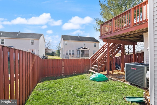 view of yard with cooling unit and a deck