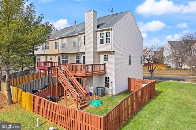 back of property featuring a yard, central AC unit, and a deck