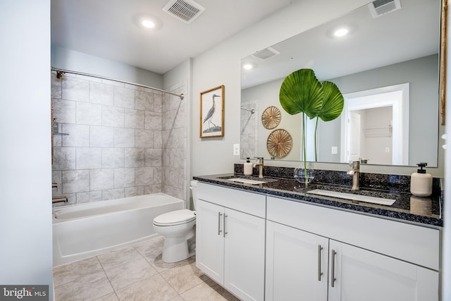 full bathroom with vanity, tiled shower / bath combo, and toilet