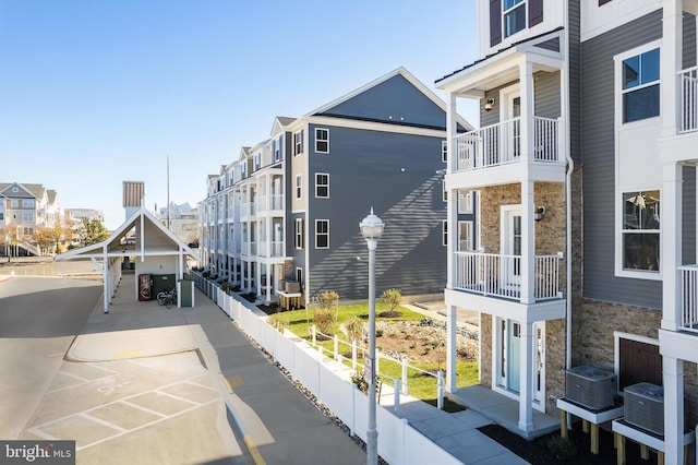 view of property featuring central AC and fence