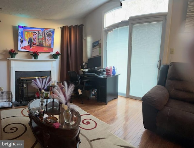 living room with hardwood / wood-style floors and a textured ceiling