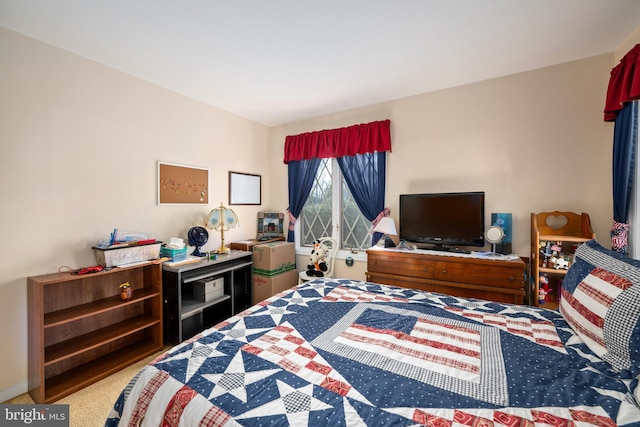 carpeted bedroom featuring baseboards