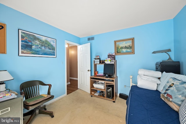 carpeted bedroom with visible vents and baseboards