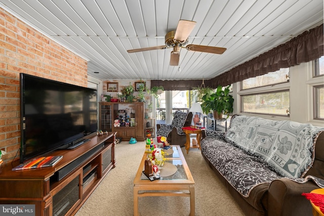 living area with carpet floors, wooden ceiling, and a ceiling fan