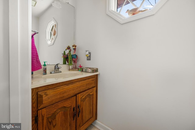 bathroom featuring a skylight and vanity