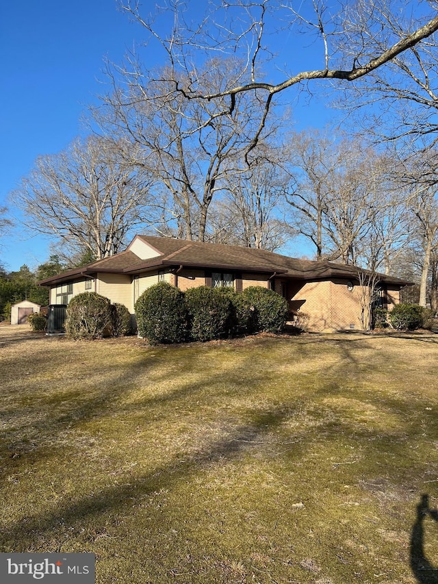 view of side of home featuring a lawn