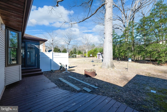 view of yard featuring a deck and fence