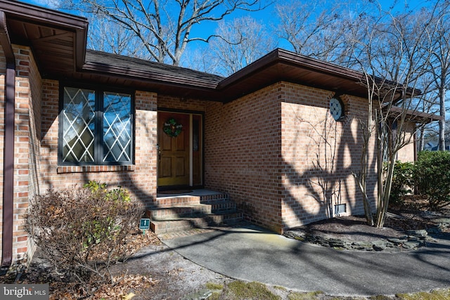 property entrance featuring brick siding