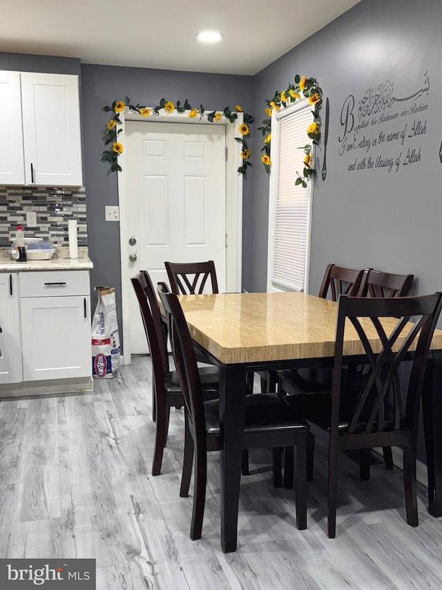 dining space with light wood-type flooring