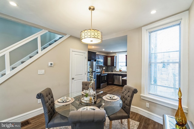 dining space with dark hardwood / wood-style flooring