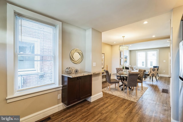 dining area featuring dark wood-type flooring