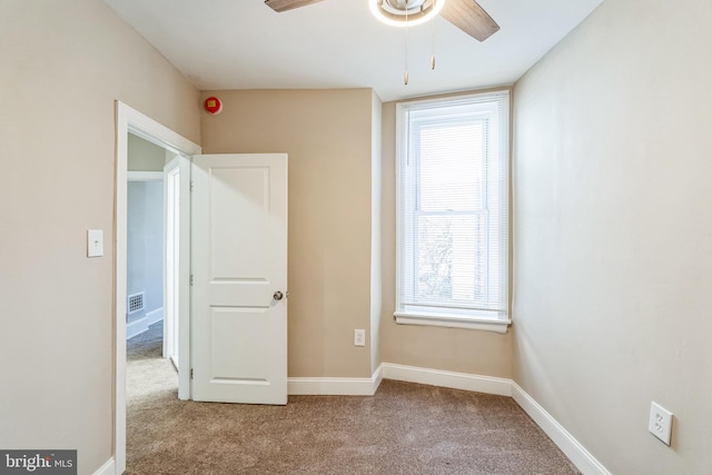 unfurnished bedroom featuring light colored carpet and ceiling fan