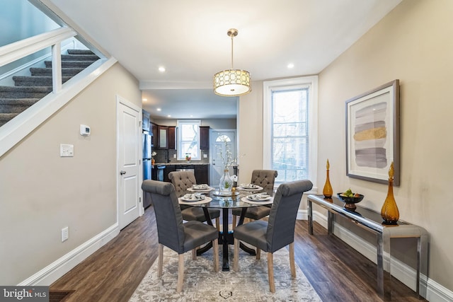 dining space with dark hardwood / wood-style floors