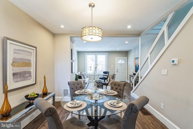 dining area with dark hardwood / wood-style floors