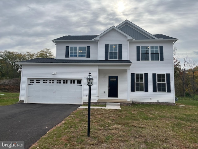 view of front of house with a garage and a front lawn