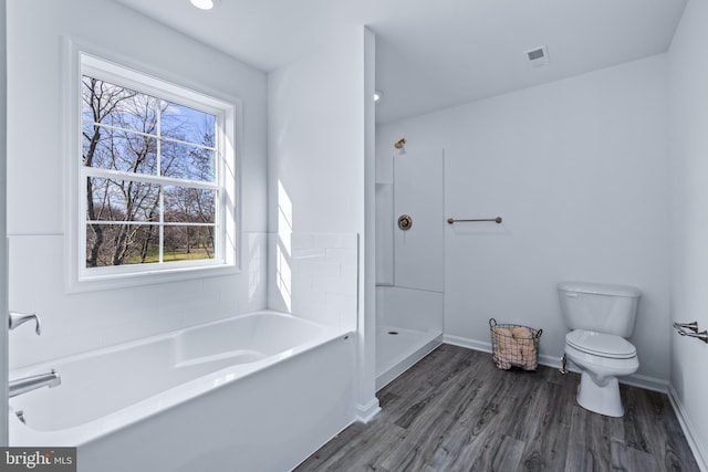 bathroom with hardwood / wood-style flooring, separate shower and tub, and toilet