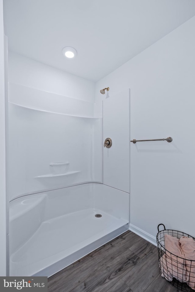 bathroom featuring hardwood / wood-style flooring and a shower