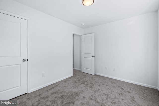 unfurnished bedroom featuring light colored carpet