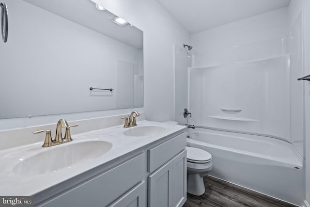 full bathroom with vanity, toilet, bathing tub / shower combination, and hardwood / wood-style floors