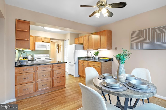 kitchen with ceiling fan, white appliances, sink, and light hardwood / wood-style flooring