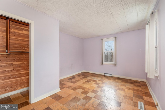 spare room featuring a textured ceiling and light parquet floors