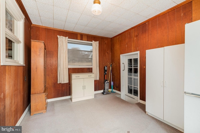 empty room with crown molding and wooden walls