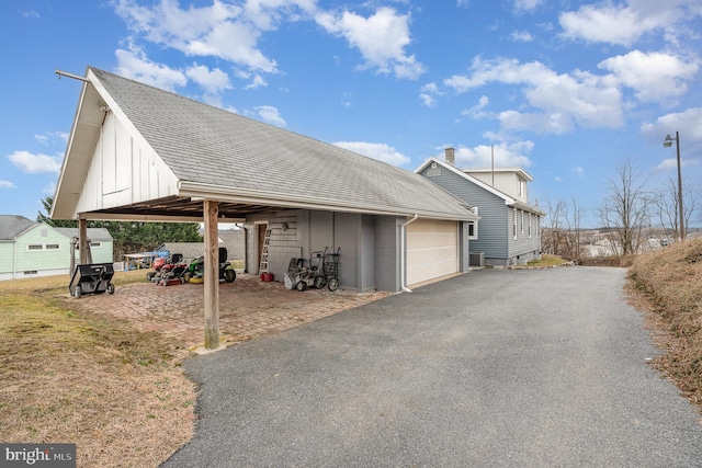 exterior space with a garage and a carport