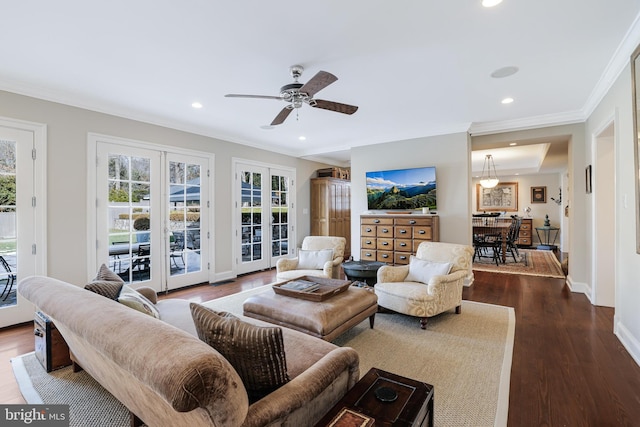 living area featuring baseboards, ornamental molding, dark wood-type flooring, french doors, and recessed lighting