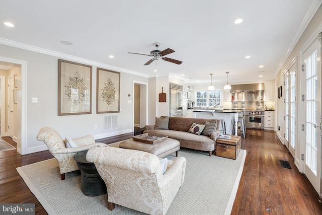 living room featuring dark wood finished floors, visible vents, crown molding, and recessed lighting