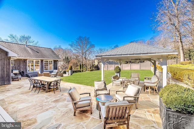 view of patio featuring fence and a gazebo