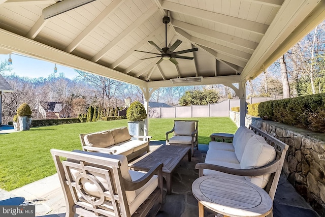 view of patio / terrace featuring a fenced backyard, an outdoor living space, a ceiling fan, and a gazebo