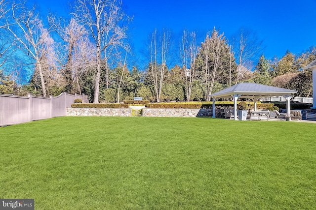 view of yard with fence and a gazebo