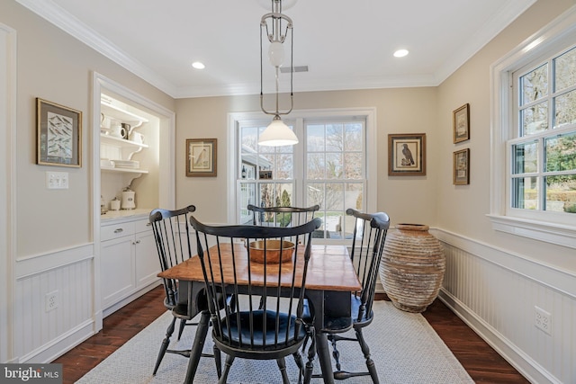 dining area with recessed lighting, a wainscoted wall, dark wood-type flooring, visible vents, and crown molding