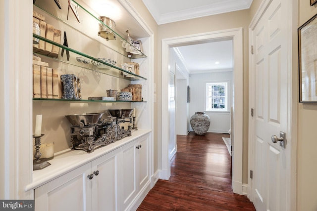 hallway featuring baseboards, dark wood-style flooring, and crown molding