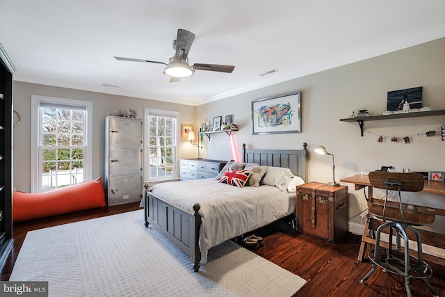 bedroom featuring ceiling fan, wood finished floors, and visible vents