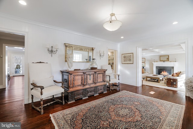 sitting room with hardwood / wood-style flooring, a wealth of natural light, and crown molding