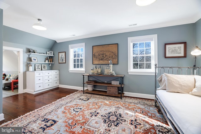 living area with vaulted ceiling, crown molding, baseboards, and wood finished floors