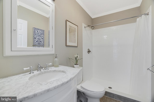 bathroom with toilet, curtained shower, ornamental molding, and vanity