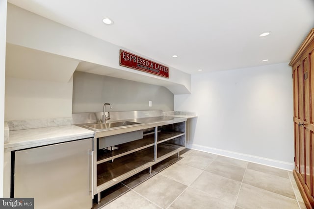 interior space with light countertops, fridge, a sink, and recessed lighting