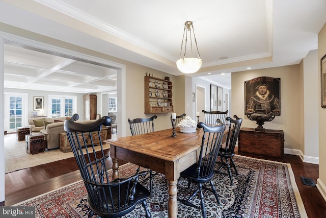 dining room featuring dark wood-style flooring, visible vents, ornamental molding, coffered ceiling, and baseboards