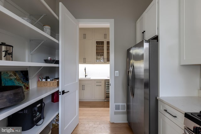 pantry with sink and beverage cooler