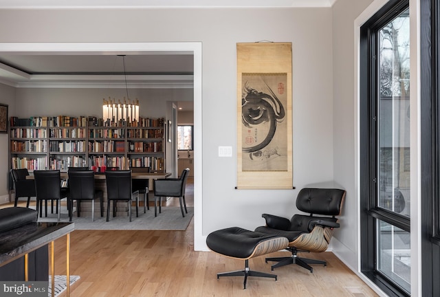 living area with a chandelier and light hardwood / wood-style floors