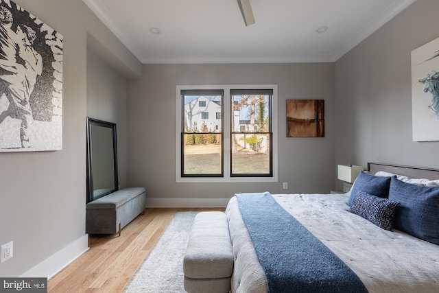 bedroom featuring ornamental molding, ceiling fan, and light wood-type flooring